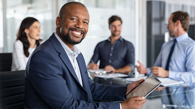 Man smiling in a office meeting