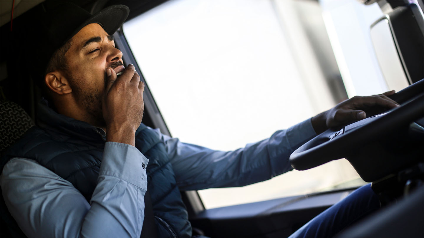 Man yawning while driving